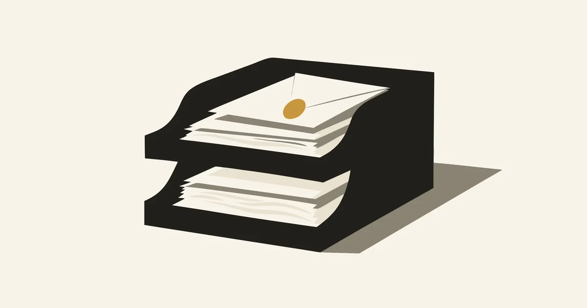 Two-tier desk letter tray stacked with papers, a gold seal on the top envelope