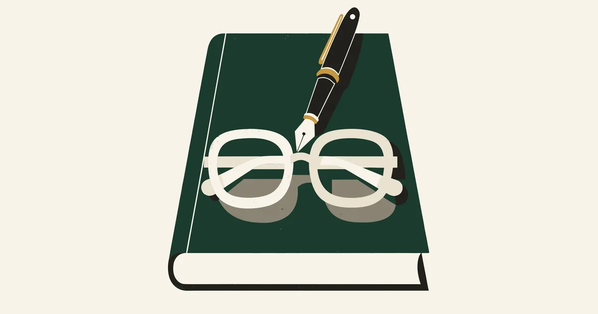 Closed green appointment diary with a gold-trimmed fountain pen and reading glasses