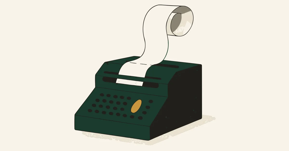 Vintage adding machine with a curl of paper tape and one gold key